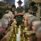 Recruits eating lunch under the watchful (and strict) eye of their drill instructor.